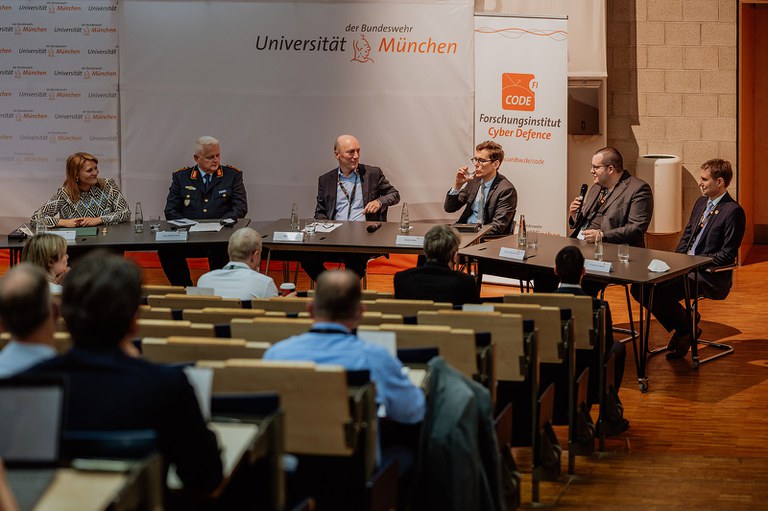 020-Angelika-Wagener-Fotografie-CODE-Jahrestagung-2022.jpg Über "Regulierung von KI und Cybersicherheit - Digitaler Aufschwung oder verpasste Chance?" diskutierten (v.l.n.r.): Lina Rusch (Moderation), GenLt Michael Vetter, Wilfried Karl, Benjamin Brake, Prof. Patrick Glauner und Dr. Arndt von Twickel.