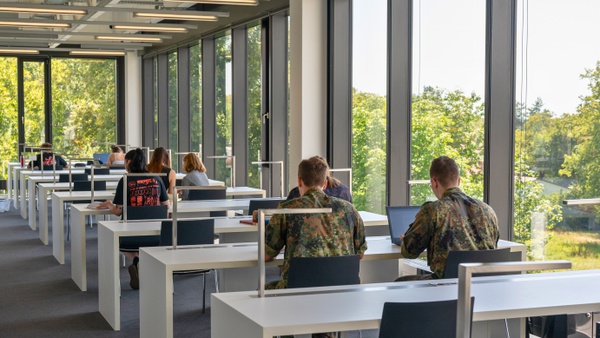 Studierende der UniBw an Arbeitstischen in der Universitätsbibliothek